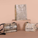 THREE NOVELTY NEWSPRINT HANDBAGS, 1970S - 2000S