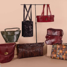 SEVEN REPTILE OR EMBOSSED LEATHER PURSES, MID 20TH C