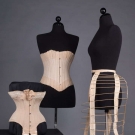 TWO CORSETS &amp; ONE BUSTLE CAGE, 1870-1890s