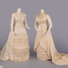 TWO CREAM SILK EVENING GOWNS, 1880s